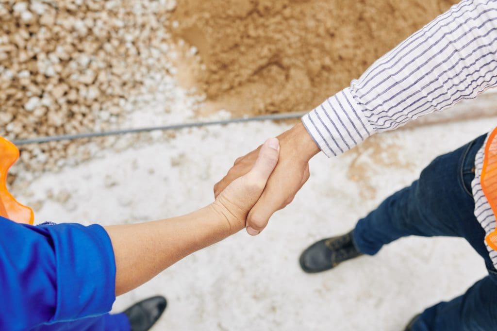 septic tank contractor and builder shaking hands